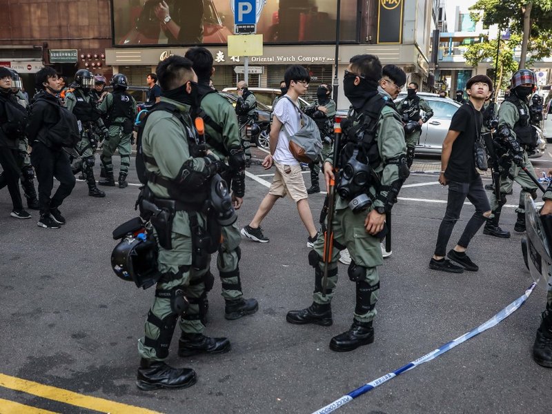 People are detained by police near the Hong Kong Polytechnic University in Hung Hom district of Hong Kong