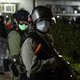 Riot police officers wearing face masks stand guard as residents protest against plans for an empty local housing estate to become a temporary quarantine camp for patients and frontline medical staff of a SARS-like virus outbreak which began in the Chines