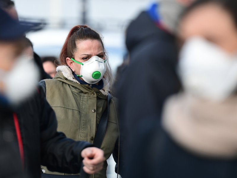 Residents wearing respiratory mask wait to be given access to shop in a supermarket in small groups of forty people on February 23, 2020 in the small Italian town of Casalpusterlengo, under the shadow of a new coronavirus outbreak, as Italy took drastic c