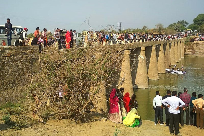 Onlookers gather after a bus ferrying a wedding party fell while crossing a bridge over the Maiz Rover in Rajasthan's Bundi district on February 26, 2020. A bus carrying a wedding party crashed into a river February 26 in India's western state of Rajastha