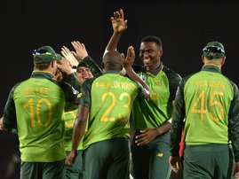 South African team members celebrate the dismissal of Australia's Pat Cummins (not seen) during their first One Day International cricket match in the three match series against Australia at Boland Park Cricket Stadium on February 29, 2020 in Paarl.