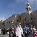 People wearing masks visit the Church of the Nativity, revered as the birthplace of Jesus Christ, in the West Bank city of Bethlehem on March 5, 2020. The Palestinian health ministry called for local churches, mosques and other institutions to close after