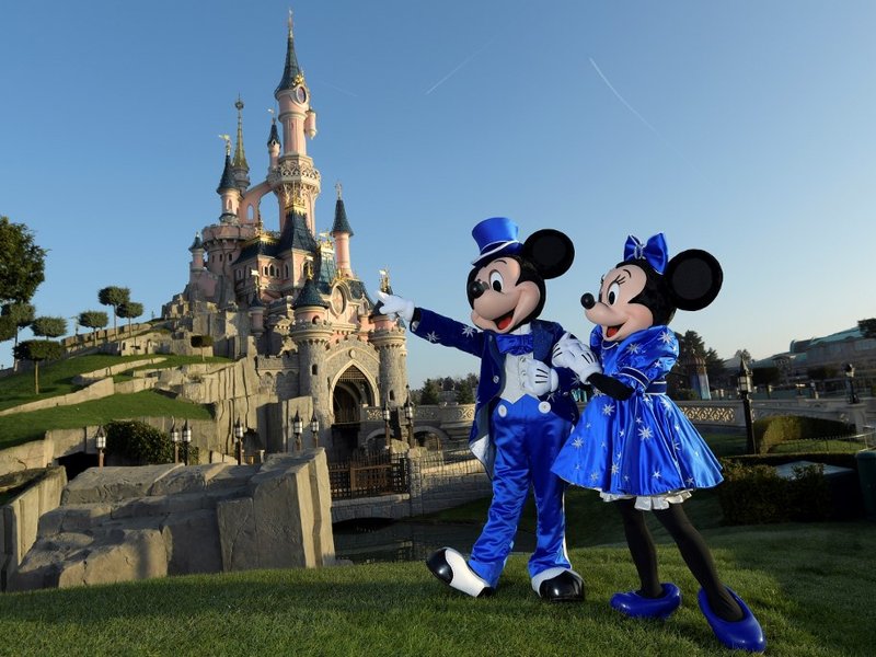In this file photo Disney characters Mickey and Mini mouse pose on March 16, 2017 in front of the Sleeping Beauty Castle to mark the 25th anniversary of Disneyland - originally Euro Disney Resort - in Marne-La-Vallee, east of the French capital Paris. Dis
