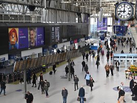 Commuters walk through a quiet Waterloo Station at 9.00am in the morning in London on March 17, 2020 after the UK government announced stricter measures and social distancing advice to deal with the novel coronavirus outbreak. Britain on Tuesday ramped up