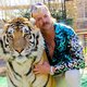 This undated photo courtesy of Netflix shows Joseph "Joe Exotic" Maldonado-Passage with one of his tigers. Amid a constant swirl of grim coronavirus news, the surreal tale of a gay, mullet-wearing private zookeeper who calls himself "Joe Exotic" -- now in