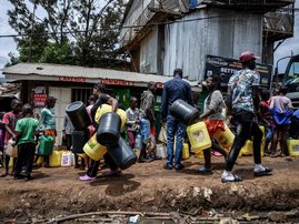 Residents queue with their jerrycan to fill them with free water distributed by the Kenyan government at Kibera slum in Nairobi, Kenya, on April 7, 2020. President Kenyatta announced the distribution of free water to low income communiites to curb the spr