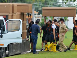 Soldiers transport cardboard boxes used as coffins at the Paque de la Paz cemetery in Guayaquil, Ecuador, on April 9, 2020 as the soaring numbers of coronavirus COVID-19 deaths in the city have led to a shortage of coffins. In the badly affected city of G