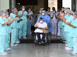 Brazilian 99-year-old former WWII combatant Ermando Armelino Piveta, gestures as leaves the Armed Forces Hospital in Brasilia, after being treated for the novel coronavirus COVID-19 and discharged, on April 14, 2020. Piveta was admitted to hospital on Apr