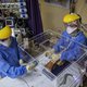 Doctor Jana du Plessis (R) and Doctor Anele Mtanjana (L) demonstrate how to use an intubox for worker safety designed at the Charlotte Maxeke Hospital in Johannesburg, on April 15, 2020. A team of medical professionals from the South African public hospit