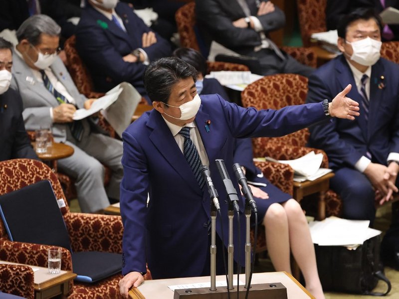 Japan's Prime Minister Shinzo Abe wearing a face mask speaks during a budget committee session at the parliament in Tokyo on 29 April 2020.