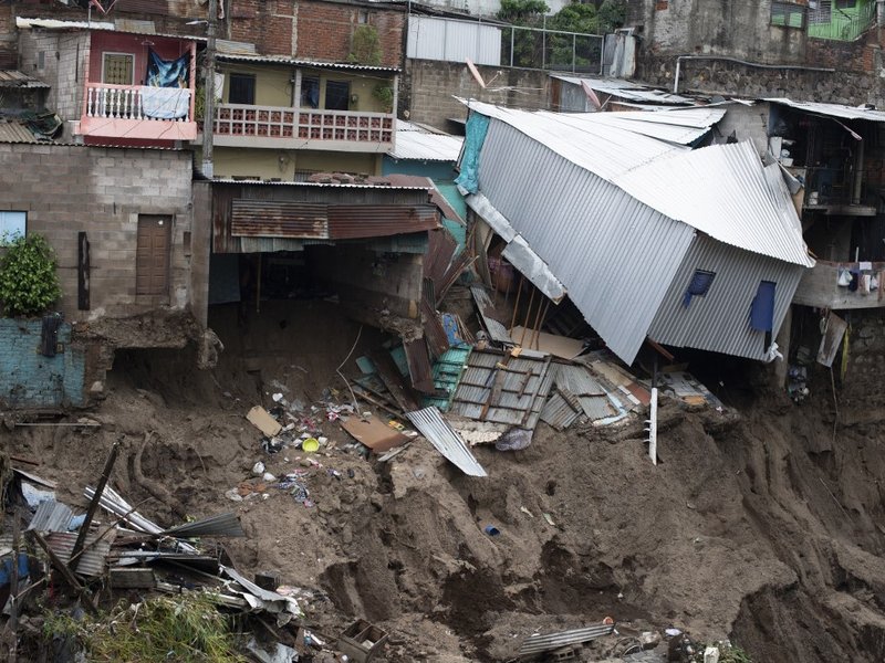 View of houses devastated by the overflowing of a creek due to the torrential rains caused by the passage of tropical storm Amanda in San Salvador on May 31, 2020. Tropical storm Amanda, the first named storm of the season in the Pacific, lashed El Salvad