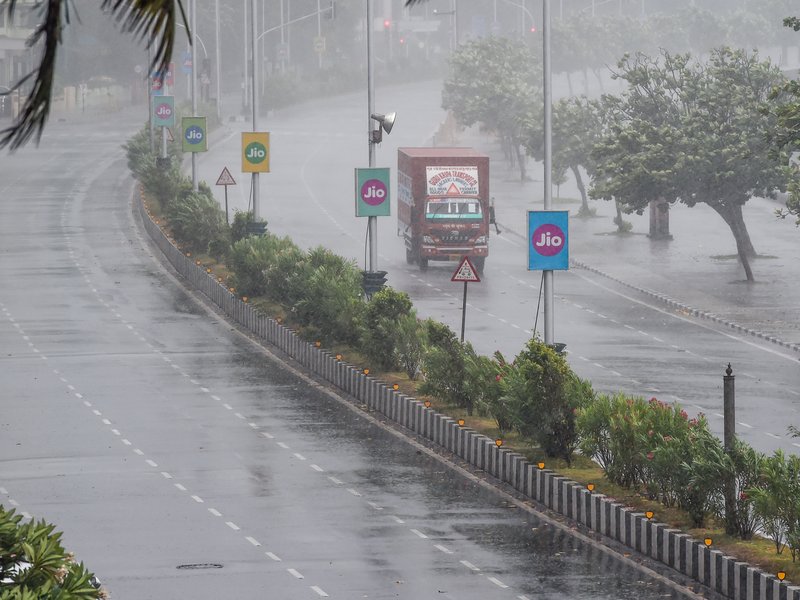 A truck drives on a road under heavy rain in Mumbai on June 3, 2020, as cyclone Nisarga barrels towards India's western coast. Mumbai authorities shut offices, banned small gatherings and told people to stay home on June 3 as the Indian megacity's first c