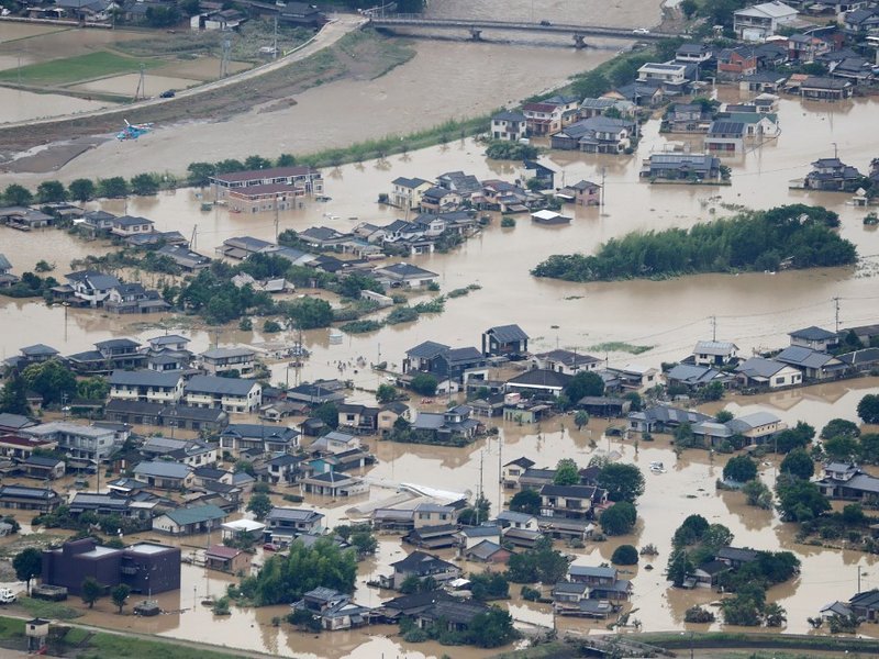 This picture shows inundated houses due to heavy rain in Hitoyoshi, Kumamoto prefecture on July 4, 2020. Fourteen people were feared dead at a nursing home in western Japan on July 4 as record rainfall triggered massive floods and landslides, forcing auth