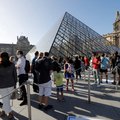 People queue at the Louvre pyramid designed by Chinese architect Ieoh Ming Pei, the entrance to the Louvre Museum in Paris, on July 6, 2020, on the museum's reopening day. The Louvre museum will reopen its doors on July 6, 2020, after months of closure du
