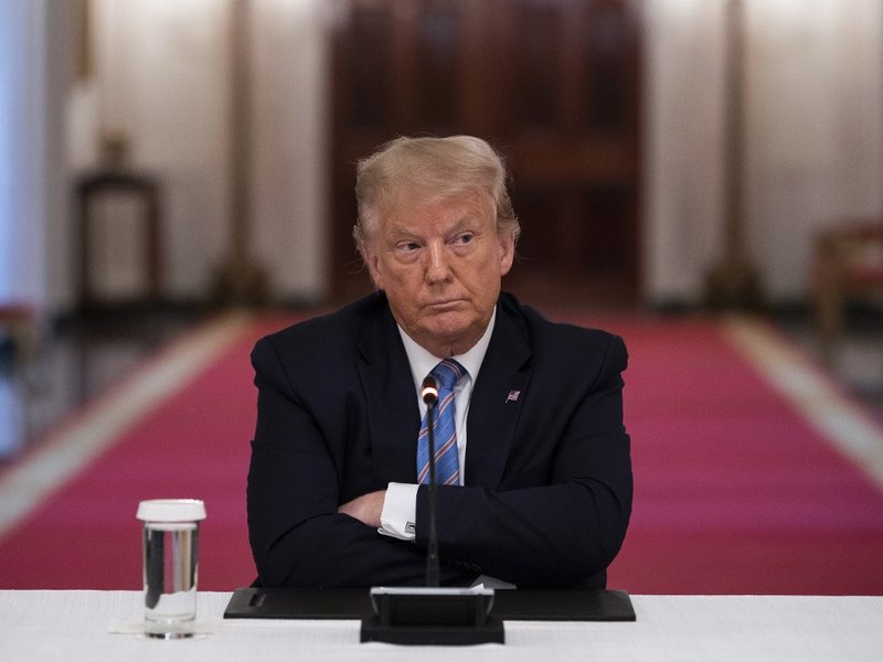 US President Donald Trump sits with his arms crossed during a roundtable discussion on the Safe Reopening of America’s Schools during the coronavirus pandemic, in the East Room of the White House on July 7, 2020, in Washington, DC.