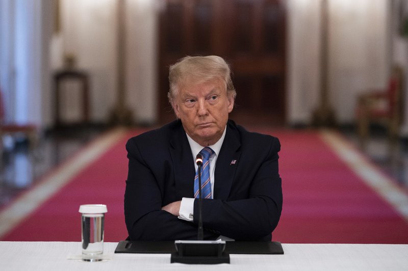 US President Donald Trump sits with his arms crossed during a roundtable discussion on the Safe Reopening of America’s Schools during the coronavirus pandemic, in the East Room of the White House on July 7, 2020, in Washington, DC.