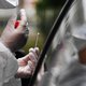 A medical staff holds a nasal swab as he collects samples from a person at a COVID-19 (the novel coronavirus) drive-in test in Brest, western France,