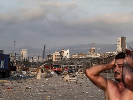 A man reacts at the scene of an explosion at the port in Lebanon's capital Beirut on August 4, 2020. Two huge explosion rocked the Lebanese capital Beirut, wounding dozens of people, shaking buildings and sending huge plumes of smoke billowing into the sk