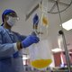 A health worker checks the plasma donated by Colombian internist and intensivist Norberto Medina, who recovered from COVID-19, as part of a research project which seeks to test the effectiveness of plasma from recovered patients in the treatment of patien