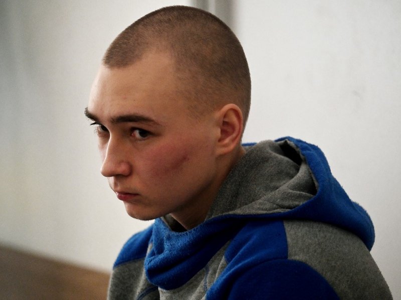 Russian soldier Vadim Shishimarin sits in the defendant's box on the second day of his trial on charges of war crimes for having killed a civilian, at a courthouse in Kyiv on May 19, 2022. The first Russian soldier on trial for war crimes in Ukraine asked