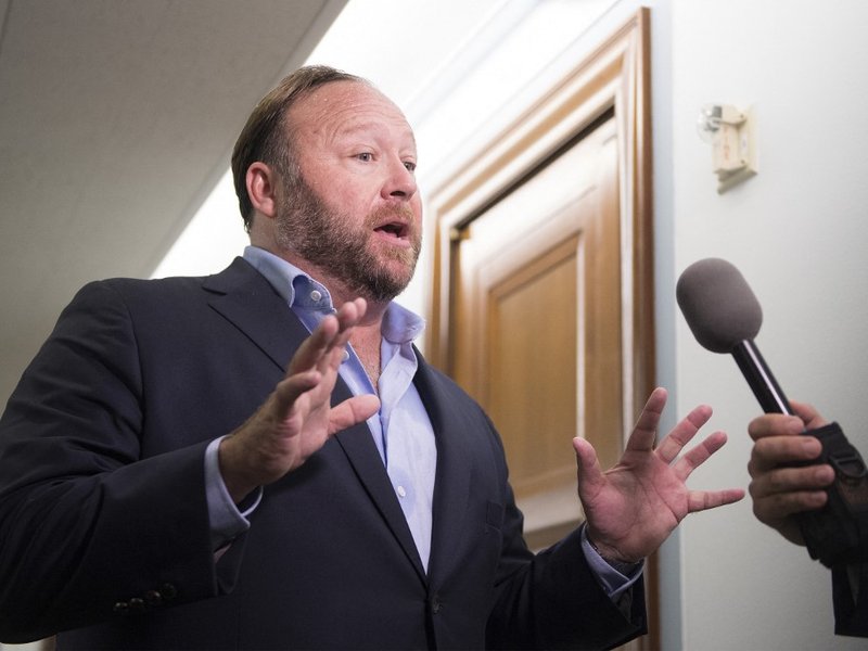 In this file photo taken on September 05, 2018 Right-wing conspiracy theorist Alex Jones speaks with reporters outside as Twitter CEO Jack Dorsey and Facebook COO Sheryl Sandberg testify before the Senate Intelligence Committee on Capitol Hill in Washingt
