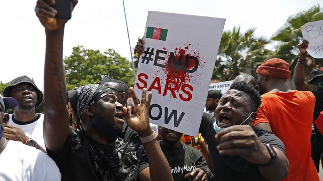Nigerians based in South Africa protest outside their embassy in Pretoria on October 21, 2020 in solidarity with Nigerian youth who are demanding an end to police brutality in the form of The Nigerian Police Force Unit, Special Anti-Robbery Squad (SARS).