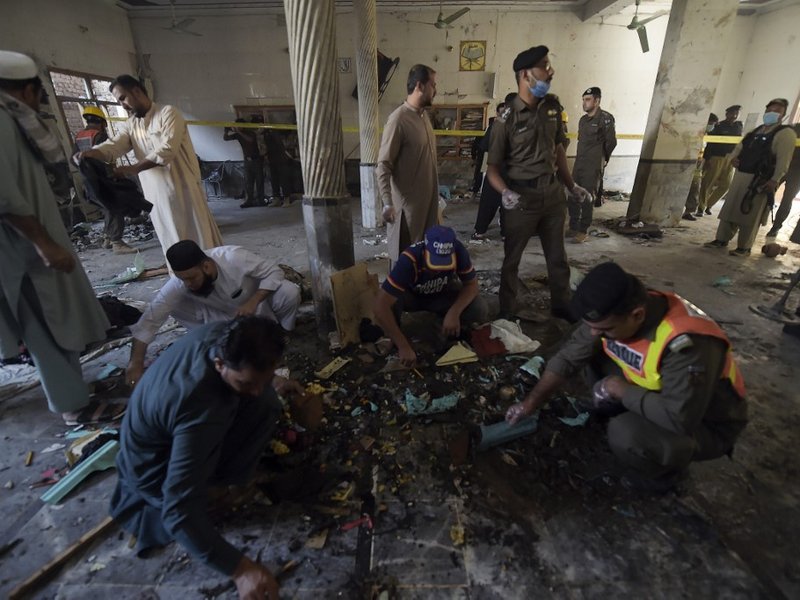 Security officials examine the site of a blast at a religious school in Peshawar on October 27, 2020. At least four students were killed and dozens more wounded on October 27 when a bomb exploded during a class at their religious school in Pakistan, offic