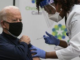 US President-elect Joe Biden receives a Covid-19 vaccination from Tabe Mase, Nurse Practitioner and Head of Employee Health Services, at the Christiana Care campus in Newark, Delaware on December 21, 2020.