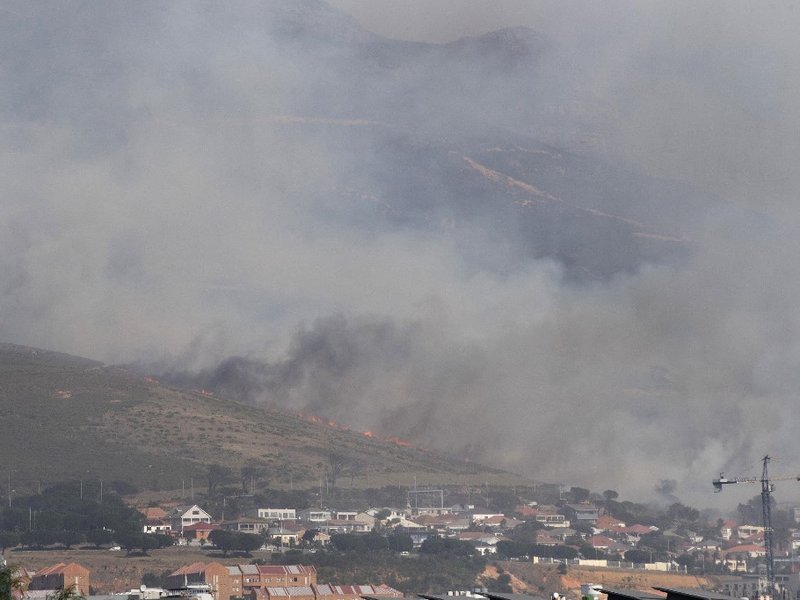 A general view of the forest fire, burning down the mountain towards Philip Kgosana Drive, one of the main arterial roads into the city centre, threatening the suburb of Walmer Estate, in Cape Town on April 19, 2021. The fire, which broke out on April 18,