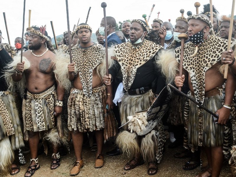 Newly elected Zulu monarch Prince Misuzulu Zulu (2nd R) arrives with Amabutho, Zulu regiments, to attend the provincial memorial service at the Khangelakamankegane Royal Palace in Nongoma on May 7, 2021 to pay his last respects to his mother the late Quee