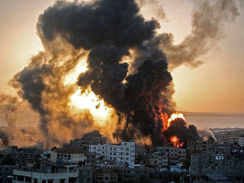 A fire rages at sunrise in Khan Yunish following an Israeli airstrike on targets in the southern Gaza strip, early on May 12, 2021. Israeli air raids in the Gaza Strip have hit the homes of high-ranking members of the Hamas militant group, the military sa