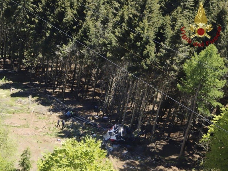 A photo taken and handout on May 23, 2021 by The Italian Firefighters "Vigili del Fuoco" shows a cable car that crashed to the ground in the resort town of Stresa on the shores of Lake Maggiore in the Piedmont region. 13 people died and two children were