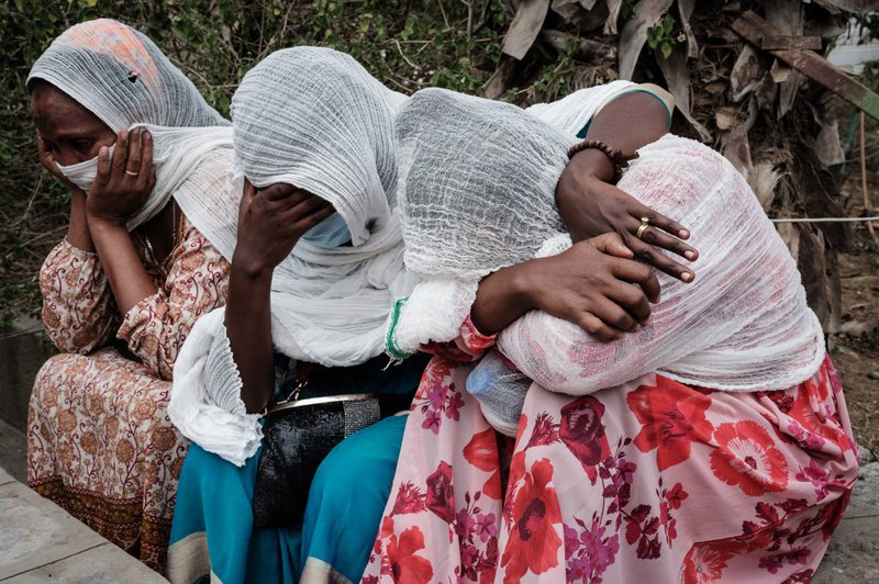 Relatives of Togoga residents, a village about 20km west of Mekele, where an alleged airstrike hit a market leaving an unknown number of casualties, wait for information as Red Cross ambulances are standing by after being denied access to the site, at the