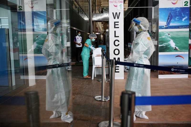 A medical worker prepares Covid-19 coronavirus swab test for international passengers arriving for the “Phuket Sandbox” tourism scheme that allows vaccinated visitors at Phuket International Airport in Phuket on July 1, 2021.