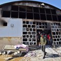 People gather at the ravaged coronavirus isolation ward of Al-Hussein hospital after a massive fire overnight, in the southern Iraqi city of Nasiriyah, on July 13, 2021.