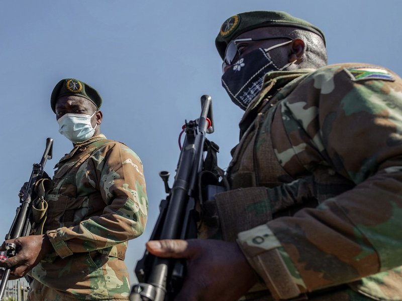 South Africa Defence Force (SANDF) soldiers stand guard in front of Maponya Mall in Soweto, on July 14, 2021. Unrest raged in South Africa on July 14, 2021, for the sixth day running, stoking fears of food and fuel shortages as disruption to farming, manu
