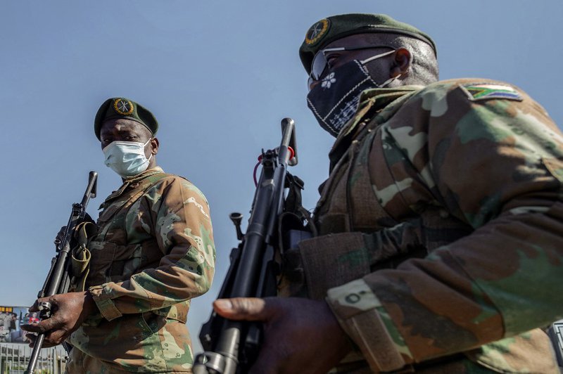 South Africa Defence Force (SANDF) soldiers stand guard in front of Maponya Mall in Soweto, on July 14, 2021. Unrest raged in South Africa on July 14, 2021, for the sixth day running, stoking fears of food and fuel shortages as disruption to farming, manu