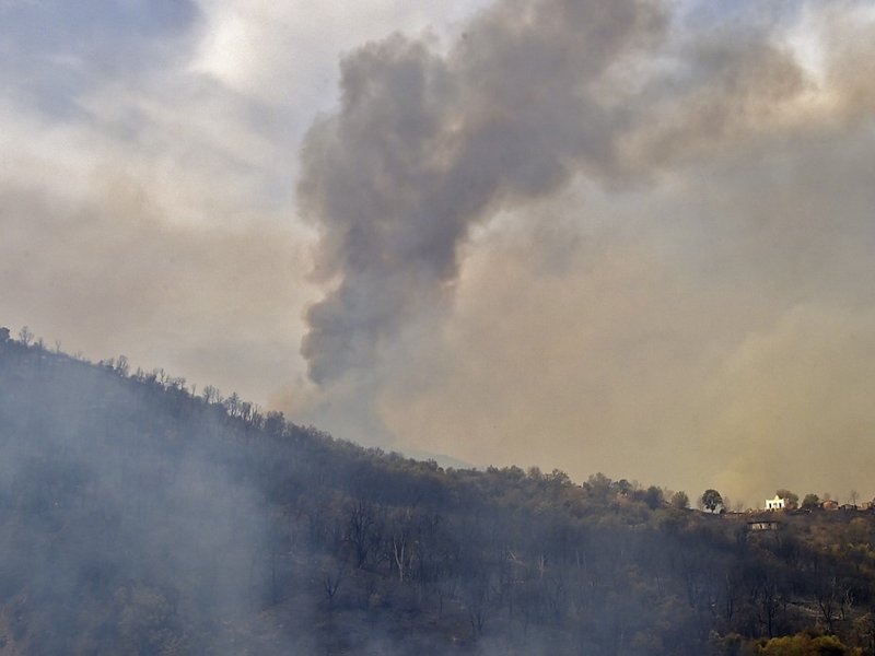 Smoke billows from a wildfire in the forested hills of the Kabylie region, east of the capital Algiers, on August 10, 2021. At least five people have died in raging wildfires in Algeria as firefighters battle more than 31 blazes amid blistering temperatur
