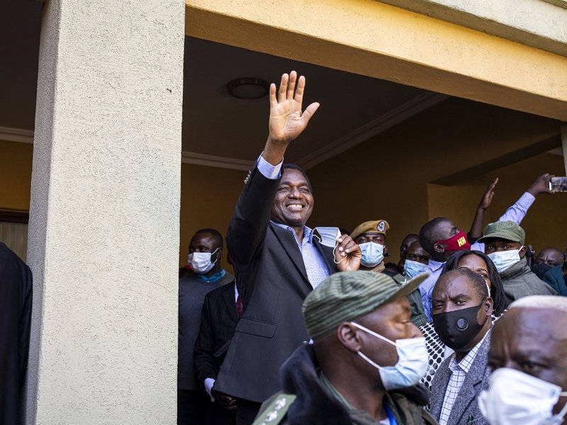 President elect Hakainde Hichilema (C) waves at supporters after a press briefing at his residence in Lusaka, on August 16, 2021. Zambian business tycoon and veteran opposition leader Hakainde Hichilema scored a landslide victory on August 16, 2021 in bit
