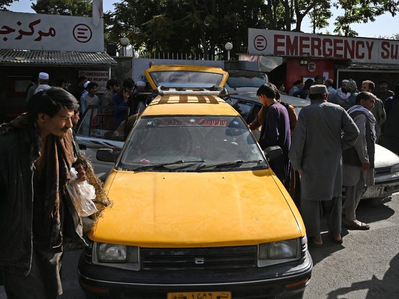 Relatives load in cars coffins of victims of the August 26 twin suicide bombs, which killed scores of people including 13 US troops outside Kabul airport, at a hospital in Kabul on August 27, 2021.