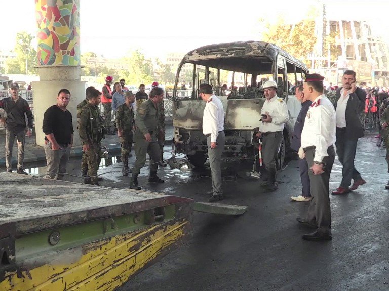 A grab from an AFPTV video shows a charred Syrian army bus, that was targeted with explosive devices in the Syrian capital Damascus on October 20, 2021. A bomb attack on an army bus in Damascus killed at least 13 people Wednesday in the bloodiest such att