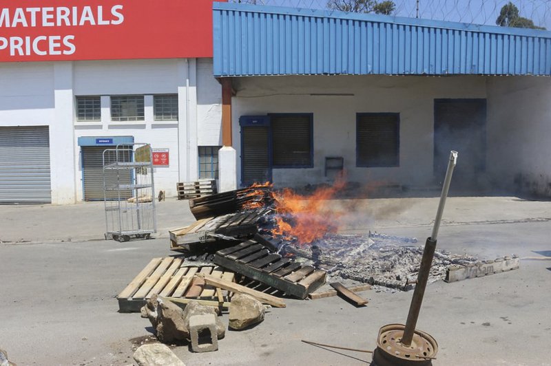 Barricades are seen in a road during a protest in Mbabane, on October 20, 2021. At least 80 people were injured in Eswatini on October 20, 2021, a union leader said, as security forces cracked down on escalating pro-democracy protests in Africa's last abs