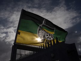 A flag of the ruling African National Congress (ANC) flies outside a polling station in Langa, near Cape Town, on November 1, 2021, during South Africa's local elections.