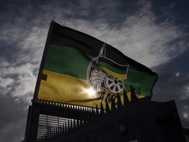 A flag of the ruling African National Congress (ANC) flies outside a polling station in Langa, near Cape Town, on November 1, 2021, during South Africa's local elections.