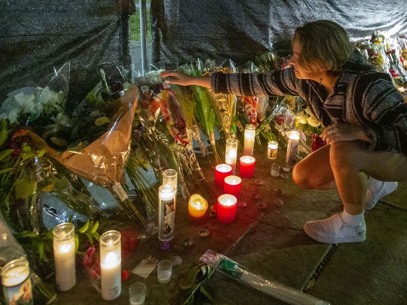 Hannah Longoria attends a makeshift memorial on November 7, 2021 at the NRG Park grounds where eight people died in a crowd surge at the Astroworld Festival in Houston, Texas. Authorities in Texas opened a criminal investigation Saturday into a tragedy in
