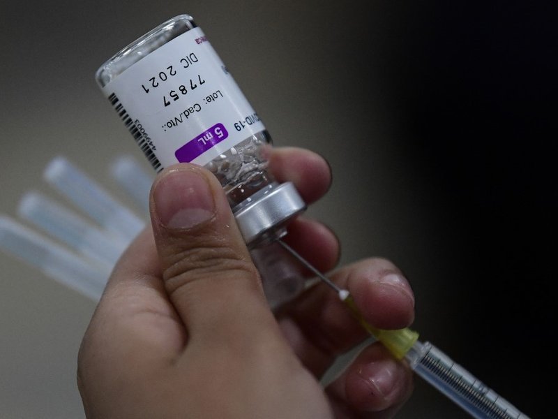 A nurse prepares a dose of the AstraZeneca vaccine against COVID-19 during the first day of the application of the third dose to people over 60 years-old at the Centro de Estudios Superiores Navales (CENCIS) in Mexico City, on December 7, 2021.