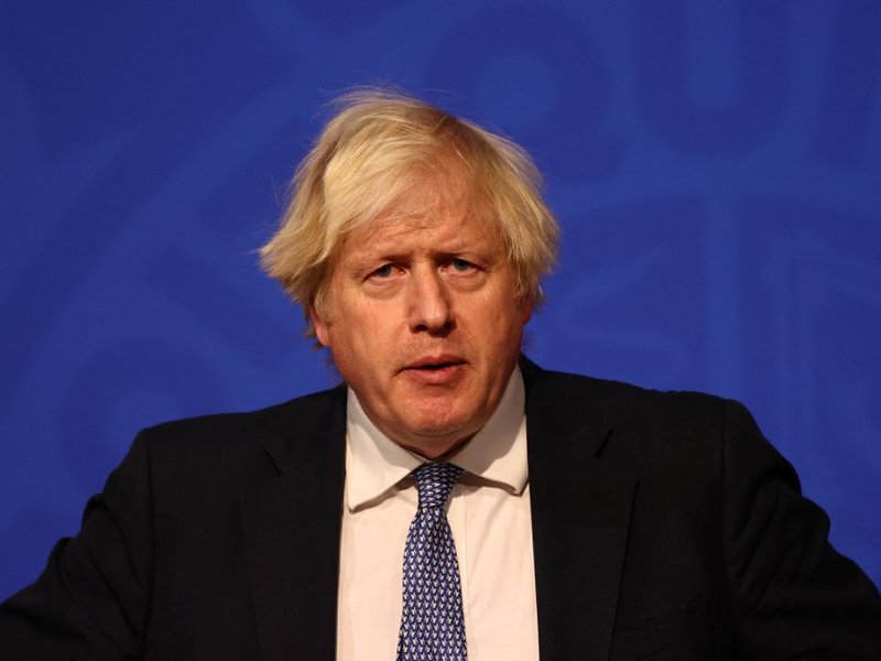 Britain's Prime Minister Boris Johnson holds a press conference for the latest Covid-19 update in the Downing Street briefing room in central London on December 8, 2021. The UK government is reintroducing Covid-19 restrictions due to the Omicron variant.
