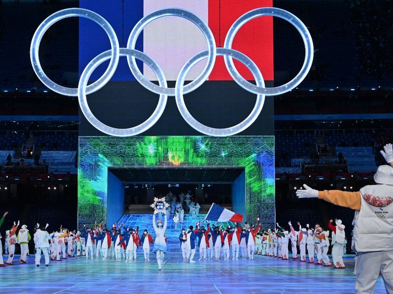 The delegation from France takes part in the parade of athletes, underneath the Olympics rings, during the opening ceremony of the Beijing 2022 Winter Olympic Games, at the National Stadium, known as the Bird's Nest, in Beijing, on February 4, 2022.