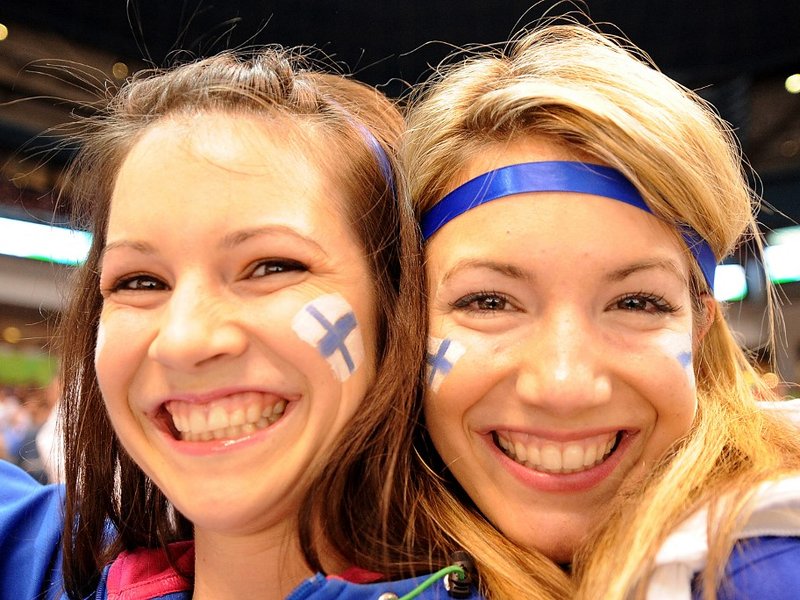 Finish fans smile during the Men's preliminary Ice Hockey match Finland (white) against Germany (black) at the XXI Winter Olympic games in Vancouver's Canada Hockey Place on February 19, 2010.