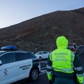 A Spanish gurdia Civil stands infrom for stopped traffic after 60 tourists became trapped in two cable car booths that ascends the El Teide Volcano (3718 meters) in the El Teide National Park on the Spanish Canary island of Tenerife generic